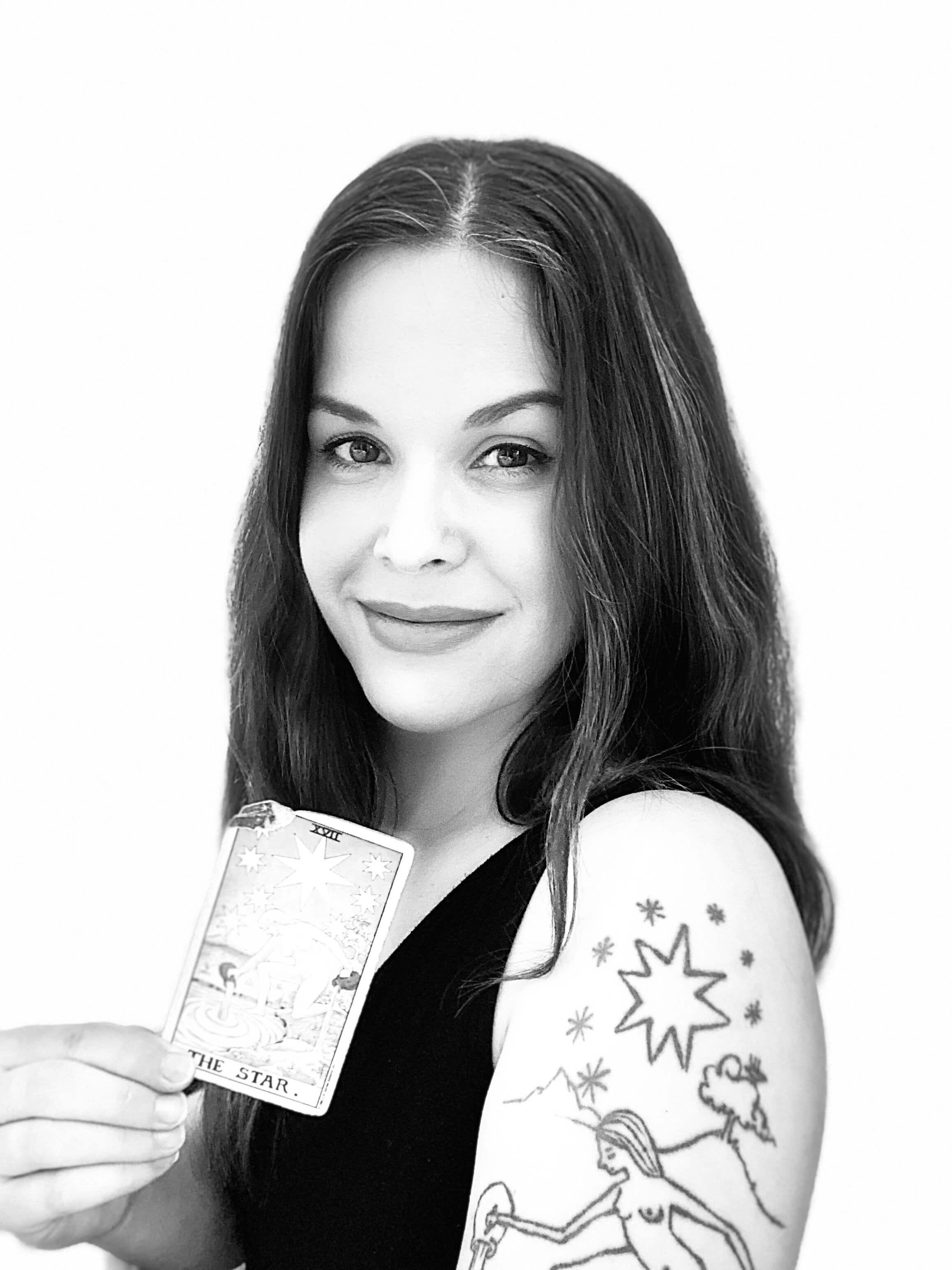 Nora Christine Wallace , Psychic Tarot Reader and Shamanic Journey Guide, holding The Star tarot card